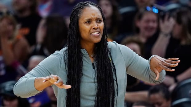 Seattle Storm head coach Noelle Quinn gives instructions to her players on the court during a game against the Phoenix Mercury.